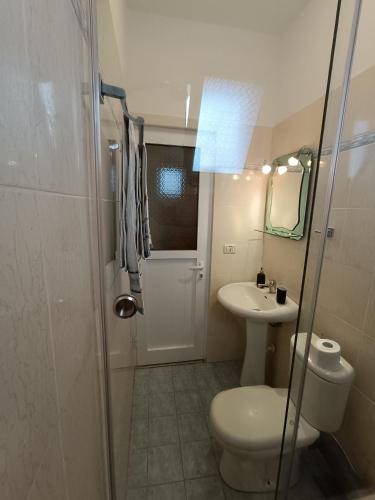 a bathroom with a toilet and a sink at Villa Papa in Ksamil