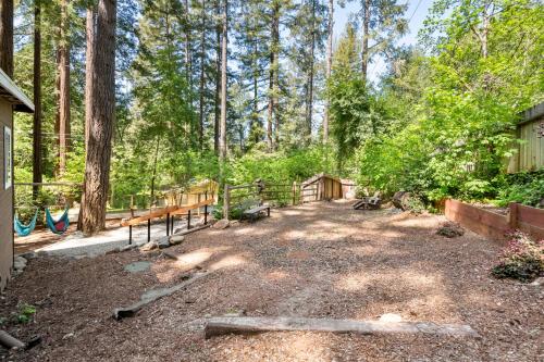 a yard with benches and a fence in the woods at Faeya Grove in Forestville