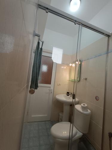 a bathroom with a shower and a toilet and a sink at Villa Papa in Ksamil