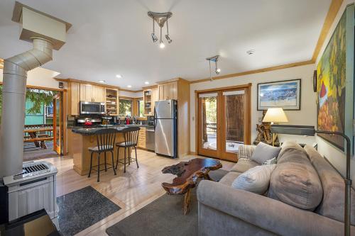 a living room with a couch and a kitchen at Willowhaven in Monte Rio