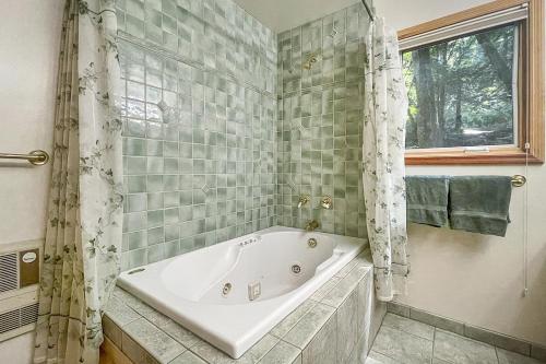 a white bath tub in a bathroom with a window at Willowhaven in Monte Rio