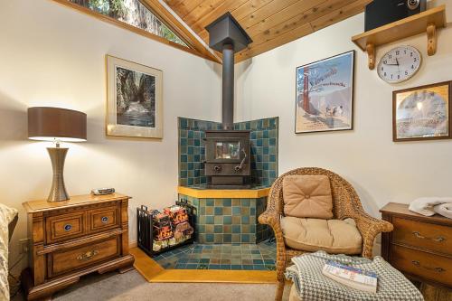 a living room with a chair and a fireplace at Willowhaven in Monte Rio