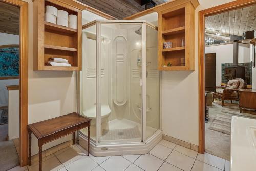 a glass shower in a room with a wooden bench at Willowhaven in Monte Rio