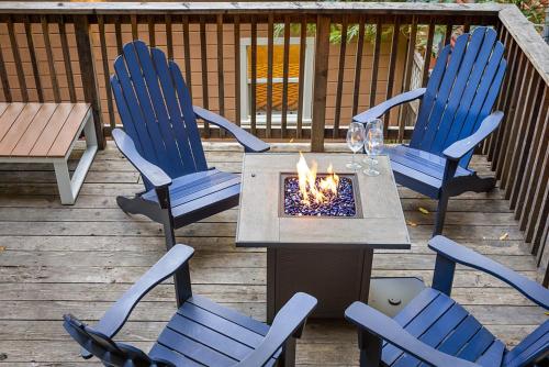 a table and chairs on a deck with a fire pit at Salmon House in Guerneville