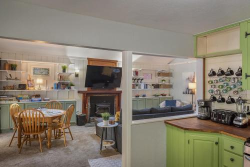 a kitchen and living room with a table and a television at Salmon House in Guerneville