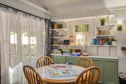 a dining room with a table and chairs and a window at Salmon House in Guerneville