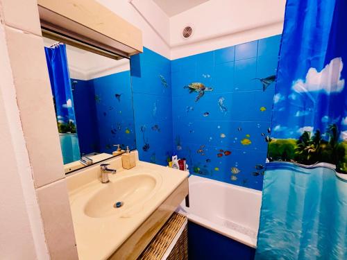 a blue bathroom with a sink and a shower at studio city center beach side free paddle beautiful terrace in Nice