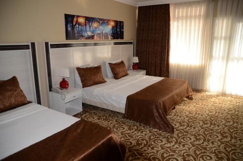 a hotel room with two beds and a window at Atamer Doga Resort in Gemlik