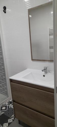 a bathroom with a sink and a mirror at Casa francisca in Arroyo de la Encomienda