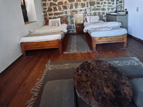 a living room with three beds and a table at El Quseir Hotel in Quseir