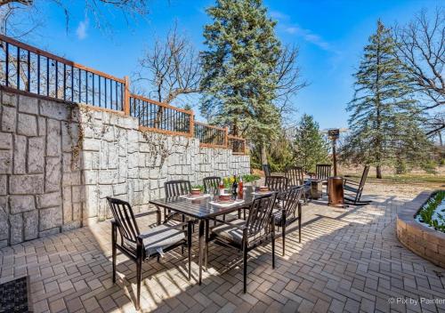a patio with a table and chairs and a stone wall at Harmony Inn, Huntley Illinois in Huntley