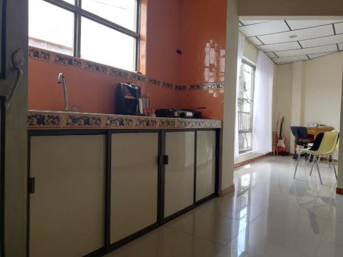 a kitchen with orange walls and a counter top at Apartaestudio central con balcón y wifi en Riosucio in Ruiosucio