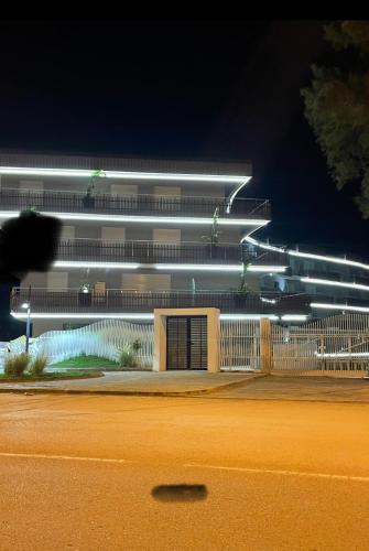 a building with lights on the side of a street at residence the wave sousse in Banī ‘Aţāʼ