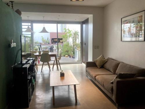 a living room with a couch and a table at Departamento tipo CASA - Palermo in Buenos Aires