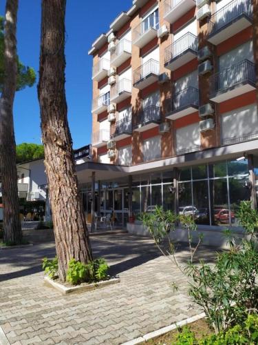 a large building with a tree in front of it at MDP B&B in Cervia