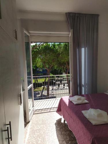 a bedroom with a bed and a sliding glass door at MDP B&B in Cervia
