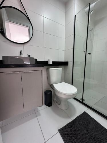 a bathroom with a toilet and a sink and a mirror at Laguna 380 - 1607B - Vista Palácio Tangará in São Paulo