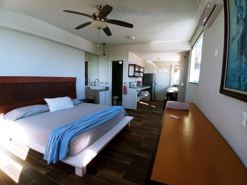 a bedroom with a bed and a ceiling fan at Moon 4 in Puerto Morelos