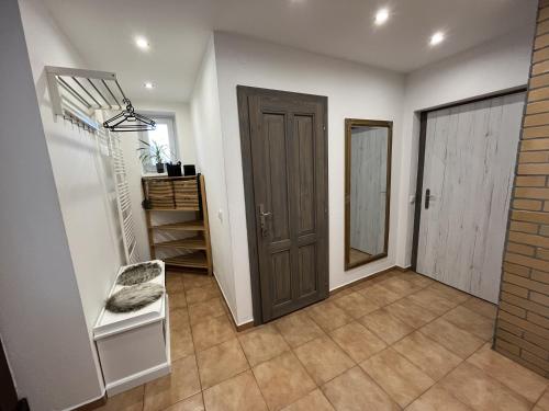 a hallway with a door and a chair in a room at Chalupa pod Zubštejnem in Bystřice nad Pernštejnem