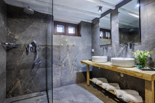 a bathroom with two sinks and a shower at Elli Cottage in Skopelos Town