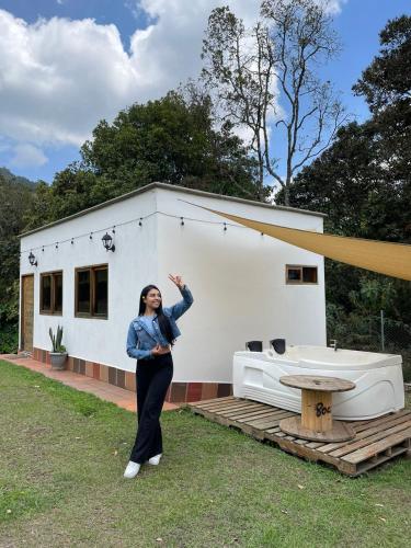 a woman standing in front of a house at Nativo House in Guarne