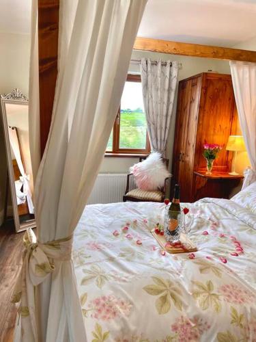 a bedroom with a bed with a canopy and a window at The Cosy Farm Cottage, Donegal in Inver