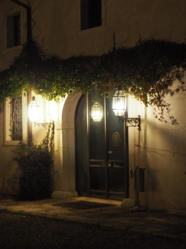 a front door of a house at night with lights at Hotel Villa Policreti in Castello dʼAviano