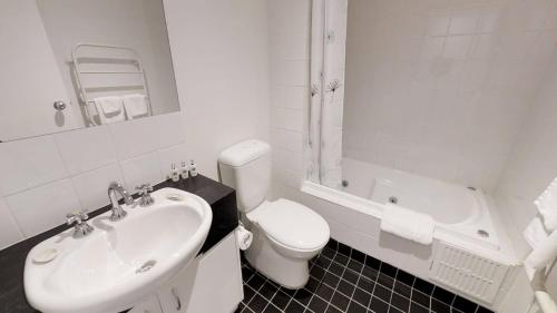 een witte badkamer met een toilet en een wastafel bij Apartment 3 The Stables Perisher in Perisher Valley