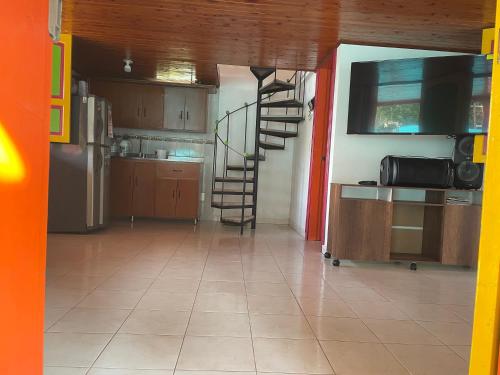 a kitchen with a spiral staircase in a room at La victoria in Marsella