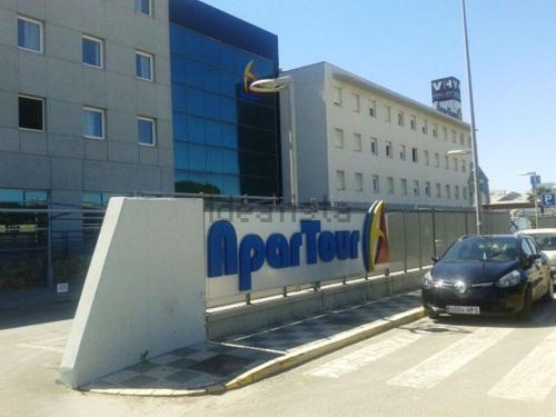 a car parked next to a ramp in front of a building at ApartHome® in Bormujos