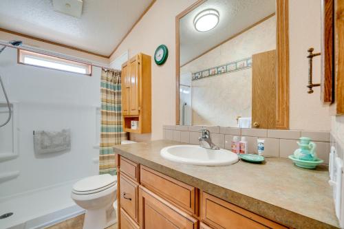 a bathroom with a sink and a toilet and a mirror at Idyllic Rock Island Home with Columbia River Views 