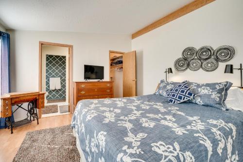 a bedroom with a bed and a dresser and a television at Idyllic Rock Island Home with Columbia River Views 