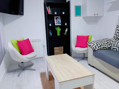 a living room with a couch and two chairs and a table at La Casita de Suances 1 in Suances