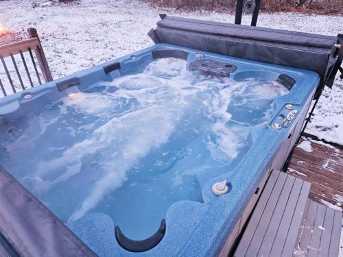 a jacuzzi tub with snow on top of it at Close to Munising, Pictured Rocks, ORV access in Shingleton
