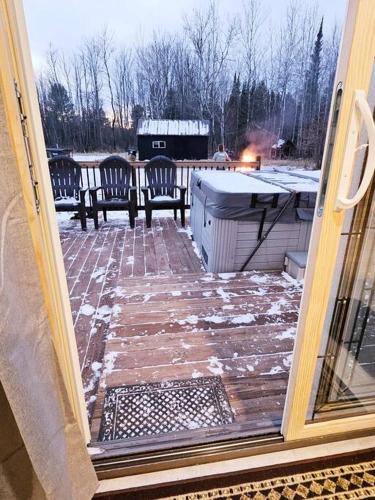 a view of a patio with two benches and snow at Close to Munising, Pictured Rocks, ORV access in Shingleton