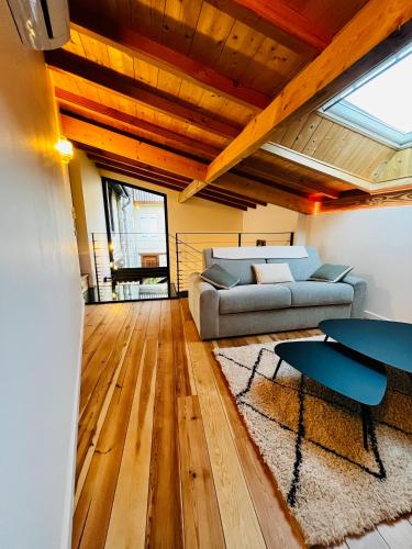 a living room with a couch and a table at Les Gites d'Andréa- Chez les Fifou in Surba