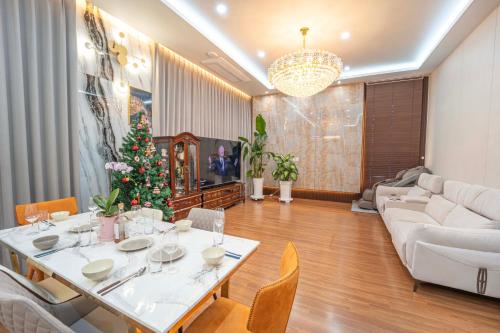 a living room with a table and a christmas tree at Boutique hotel with outdoor barbeque #pet friendly in Incheon