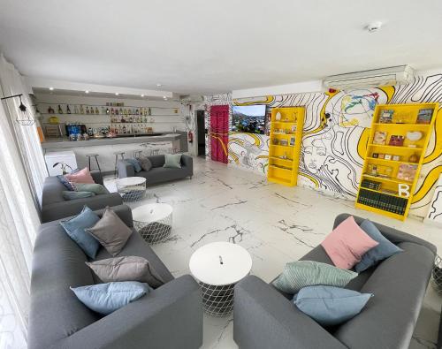 a living room with couches and a mural at Hotel Maremagnum in Lloret de Mar