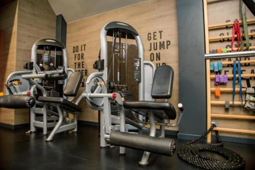 a gym with several rows of exercise bikes and weights at Adoro Titova Vila in Zlatibor