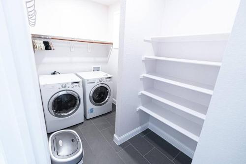 a laundry room with a washer and dryer at ※ Cul-de-Sac Haven, Stylish & Tranquil ~ King Beds in Forney