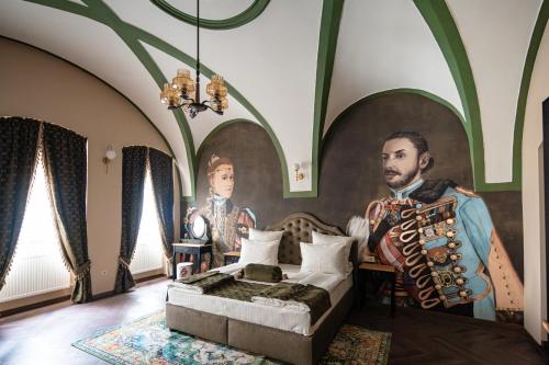 a room with a painting of a man and a bed at VICTORIAN HOUSE in Sibiu