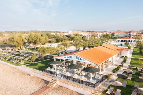 an aerial view of a resort with tables and umbrellas at Kalamaki Beach Hotel, Zakynthos Island in Kalamaki