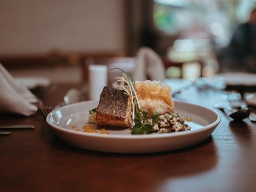 a plate of food on a wooden table at Plaza El Bosque Ebro in Santiago