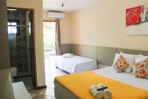 Ένα ή περισσότερα κρεβάτια σε δωμάτιο στο Lonier Praia Inn Flats