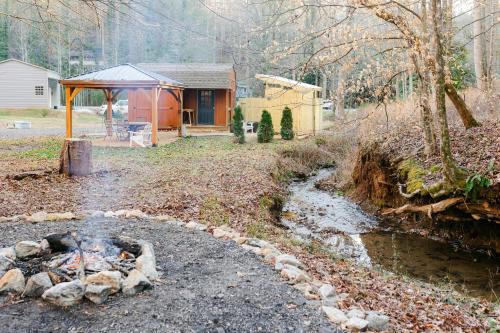 a house with a tent next to a stream at Blythe Shoals Base Camp in Cleveland