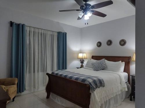 a bedroom with a bed with a ceiling fan at Casa el Huasteco ! in Escazu