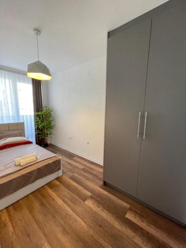 a bedroom with a large closet and a bed at Center apartment in Gjilan