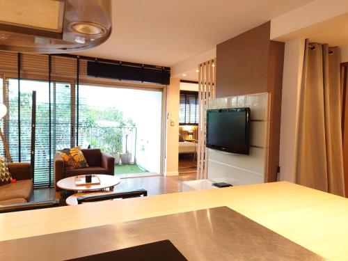 - un salon avec un canapé et une télévision dans l'établissement SUNRISE & SUNSET PALM BEACH CROISETTE, à Cannes