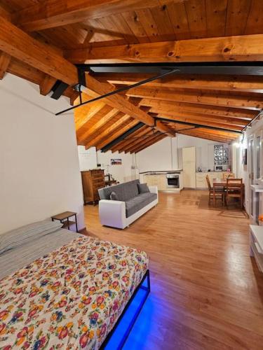 a bedroom with a bed and a couch in a room at The view Lake ,Appartamento Blevio Fronte lago Como in Blevio