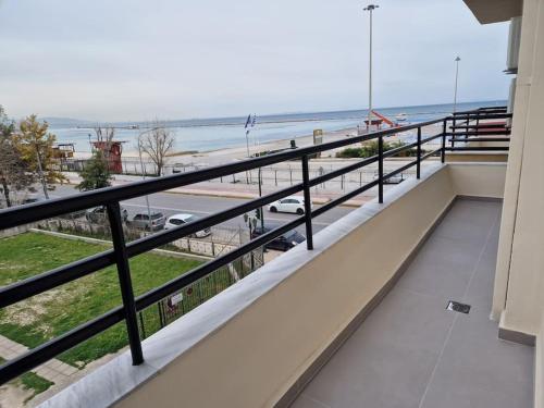 a balcony with a view of the beach at Patras Blue Sea and Sky Deluxe Apartment in Patra